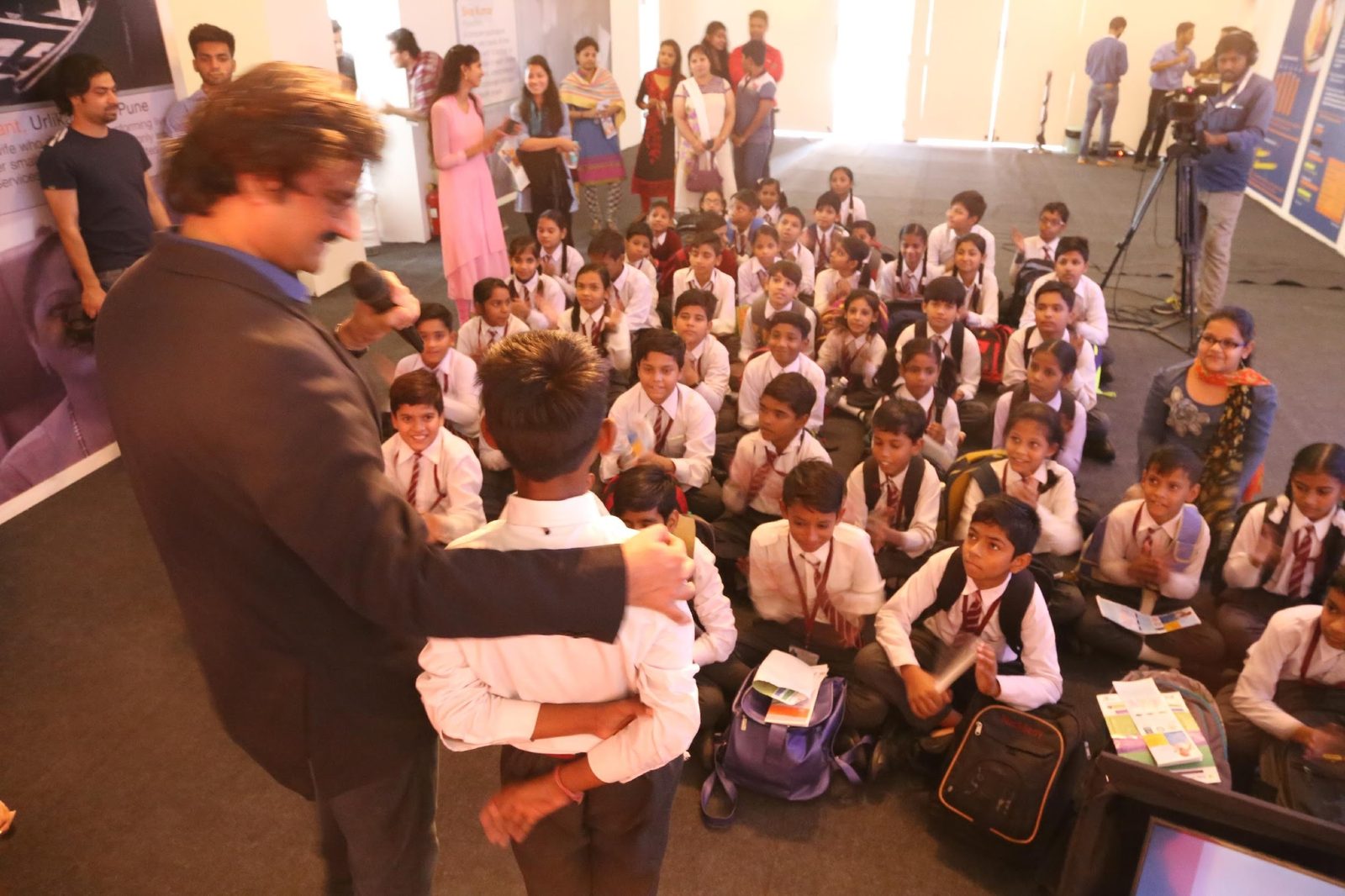A volunteer interacting closely with a young student